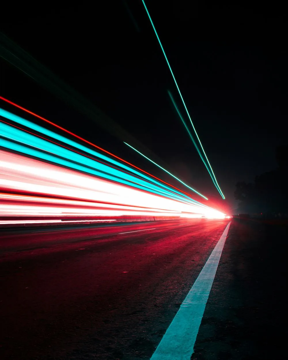 Long-exposure light trails along a highway at night, the kind of scene a LiDAR sensor maps for autonomous vehicles.